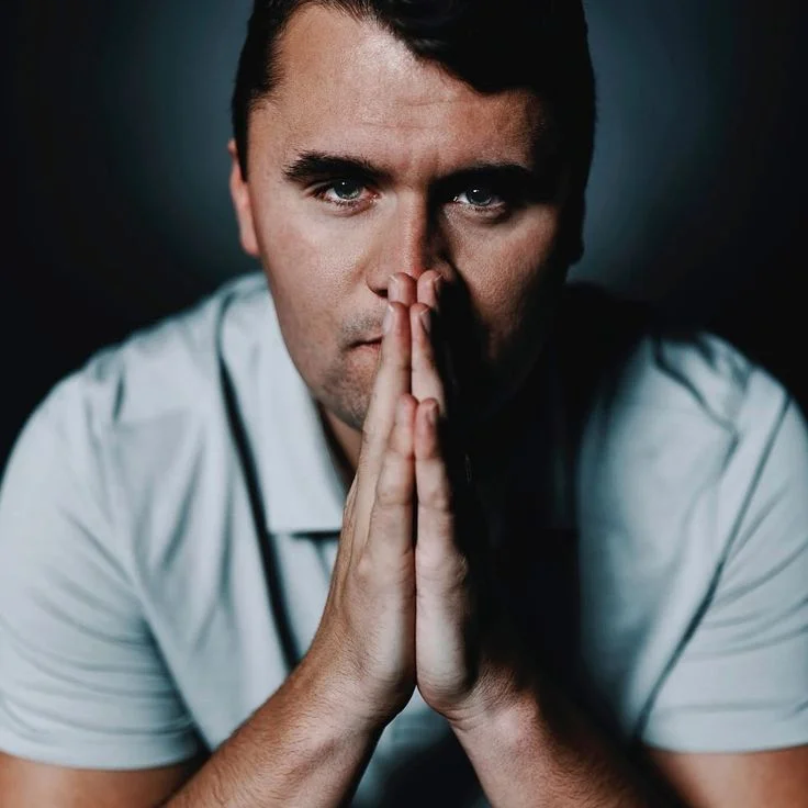 A man with his hands clasped to his face