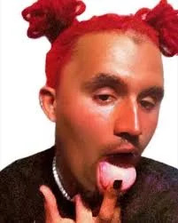 A man with red hair and a pink tongue
