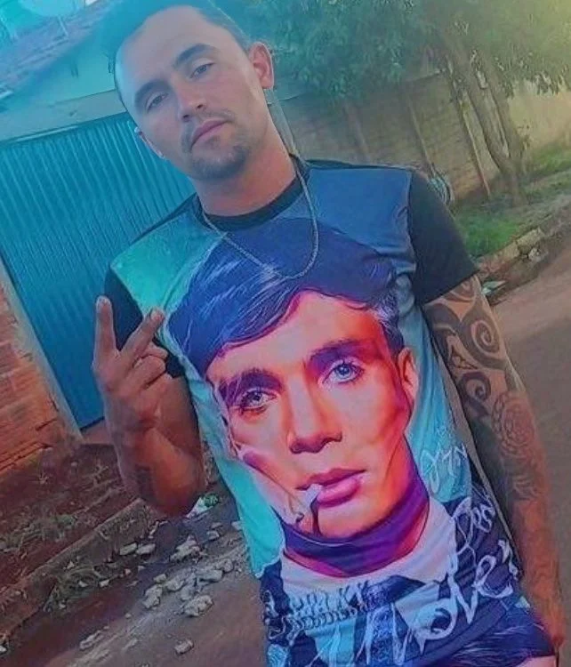 A man with tattoos and a t - shirt