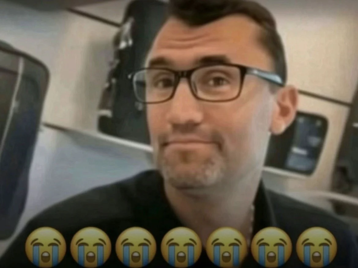 A man with glasses and a black shirt