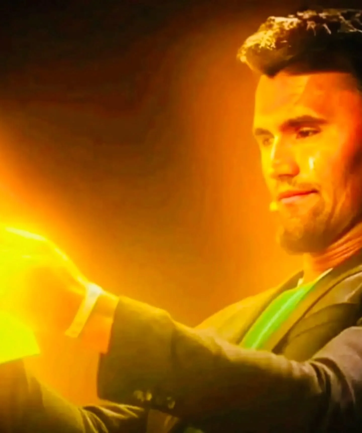 A man in a suit holding a light