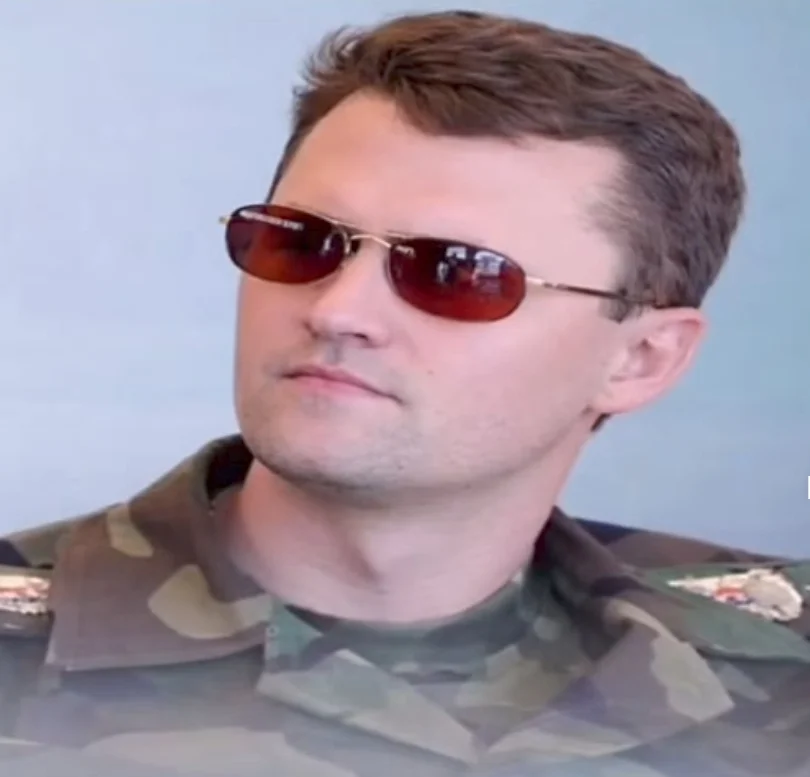 A man in a military uniform and sunglasses
