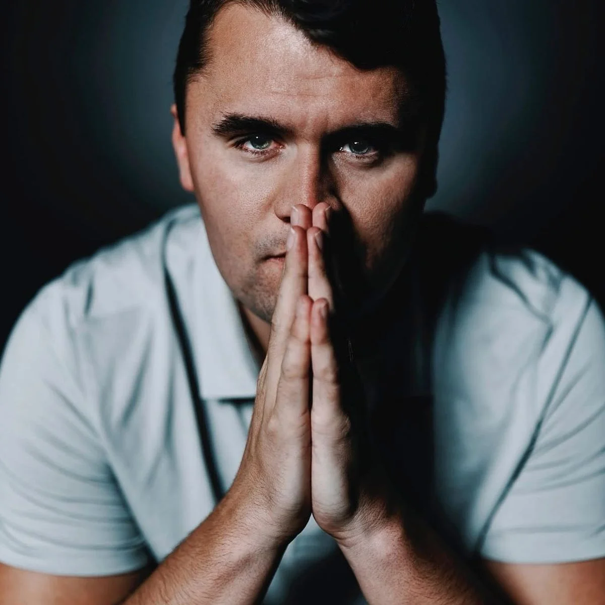 A man with his hands clasped to his face