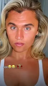 A woman with blonde hair and a white tank top