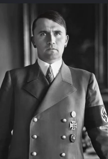 A man in uniform standing in front of a building