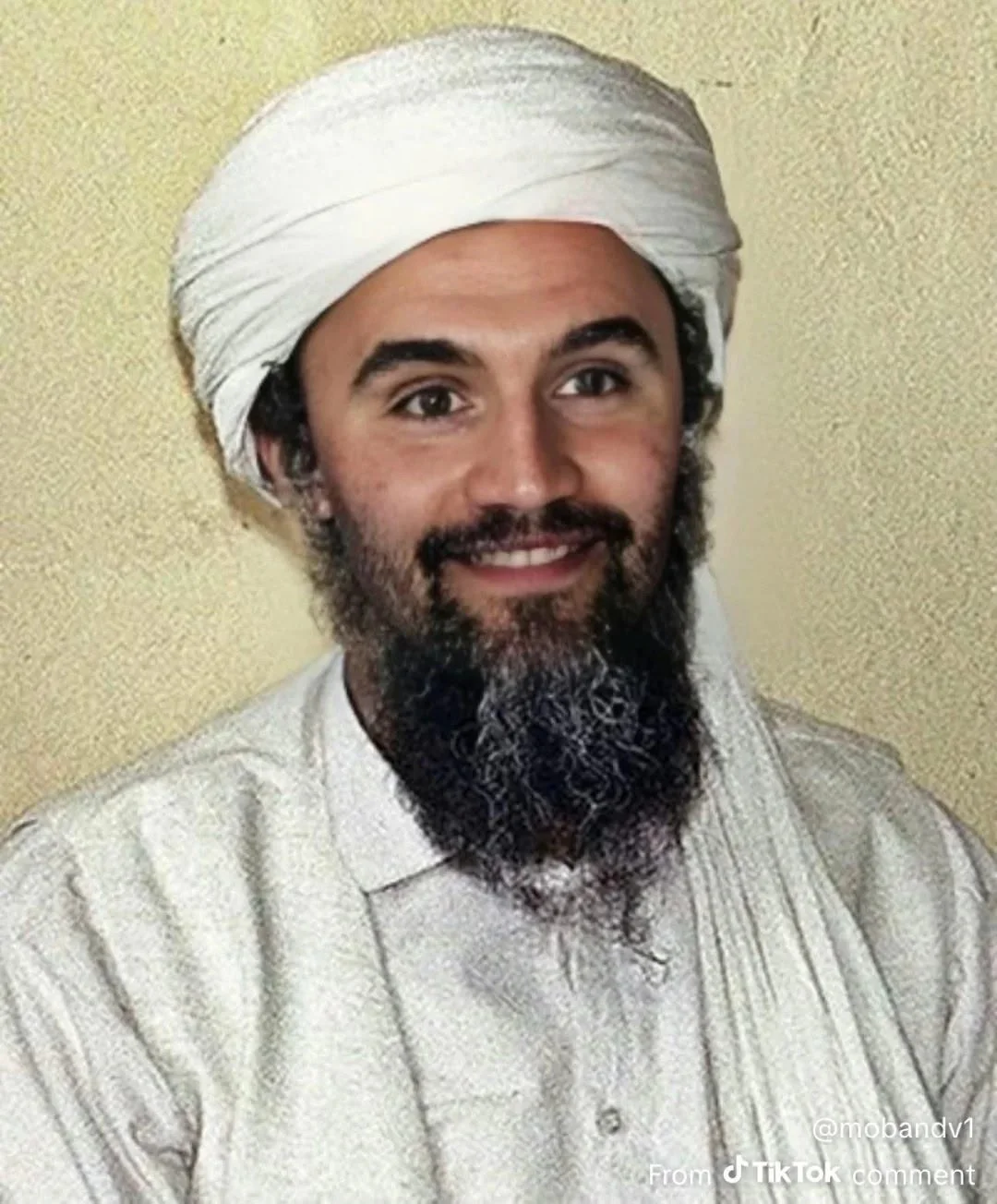 A man with a beard and a white turba
