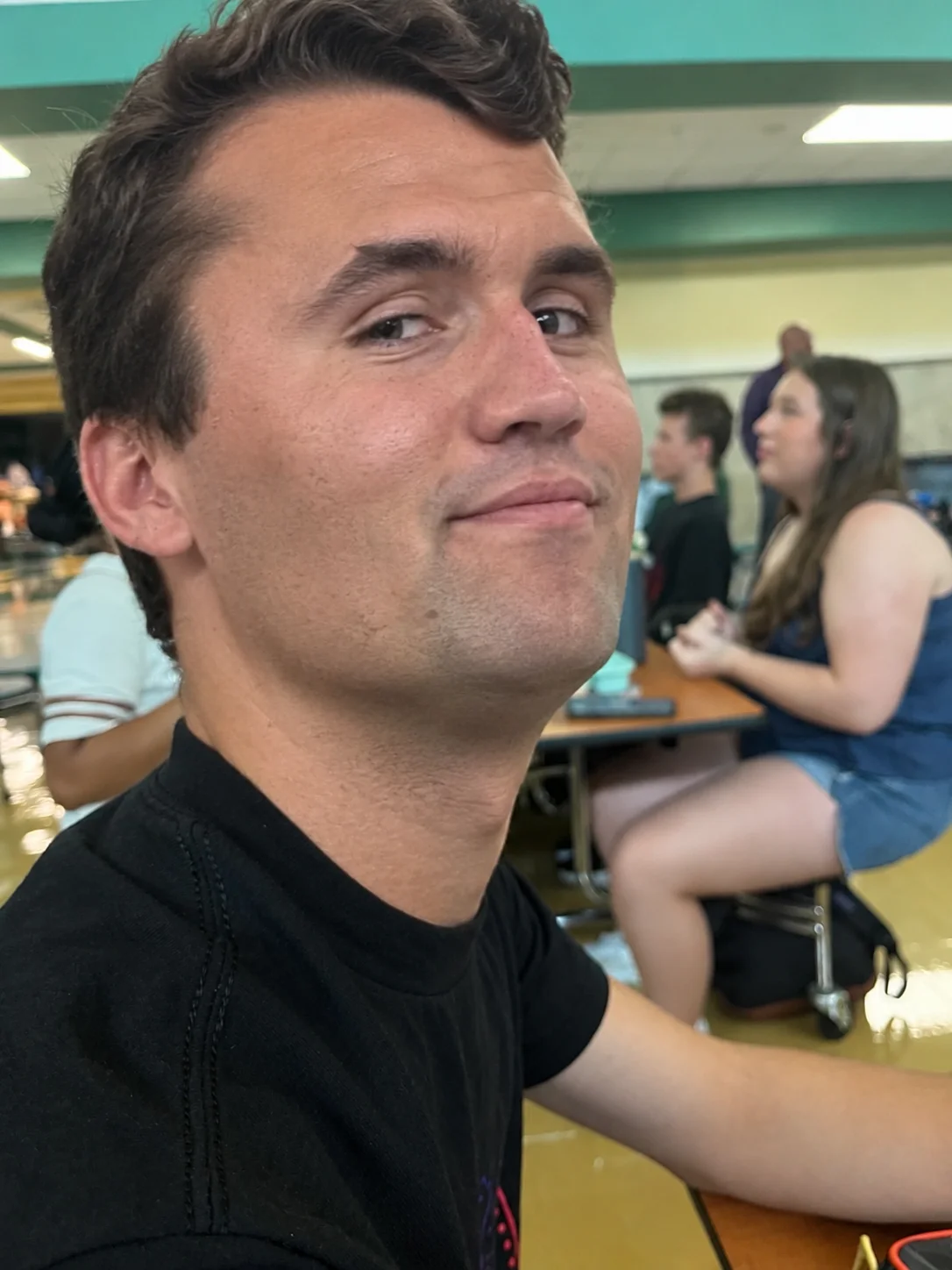 A man sitting at a table with a plate of food