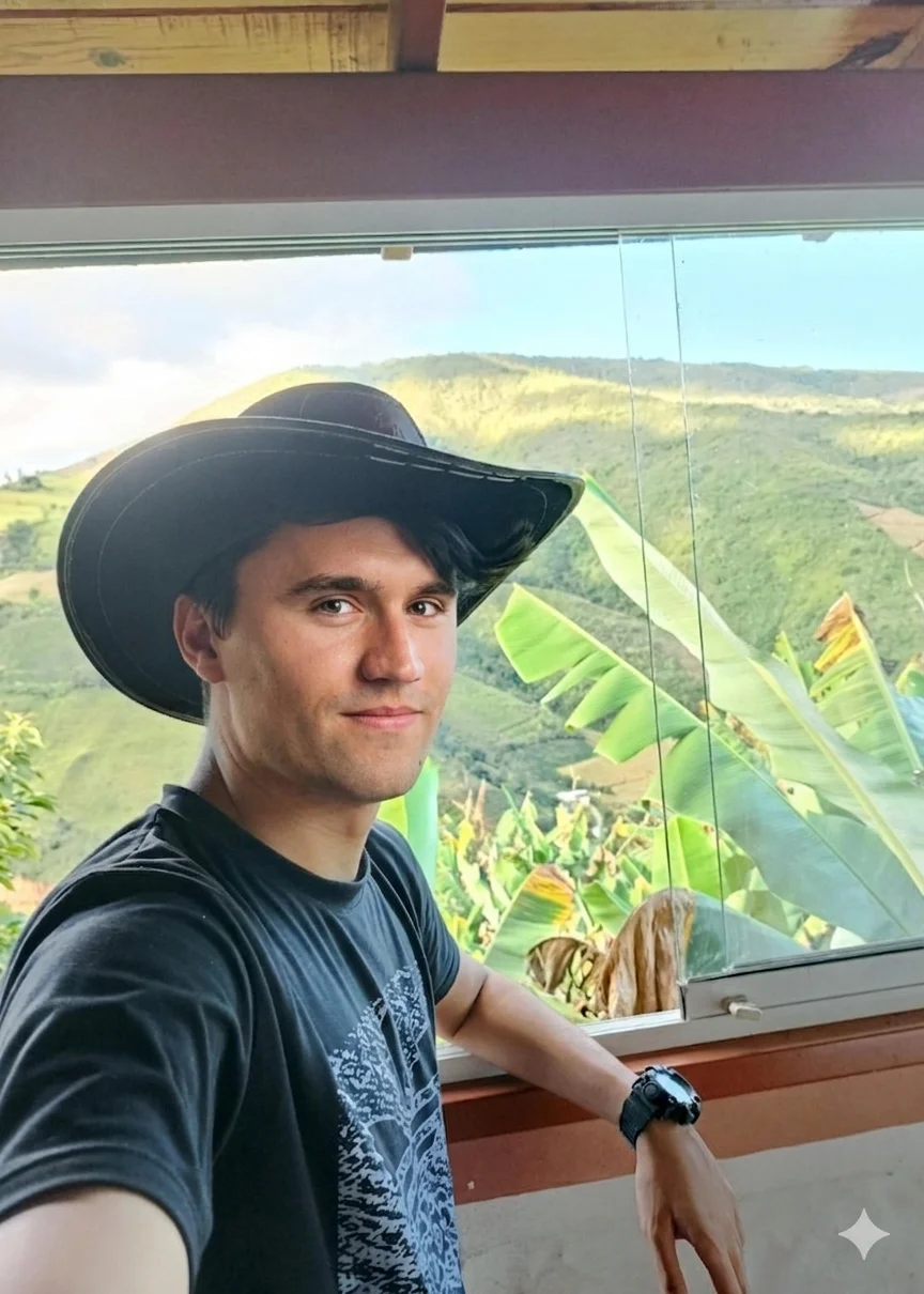 A man in a hat is looking out the window