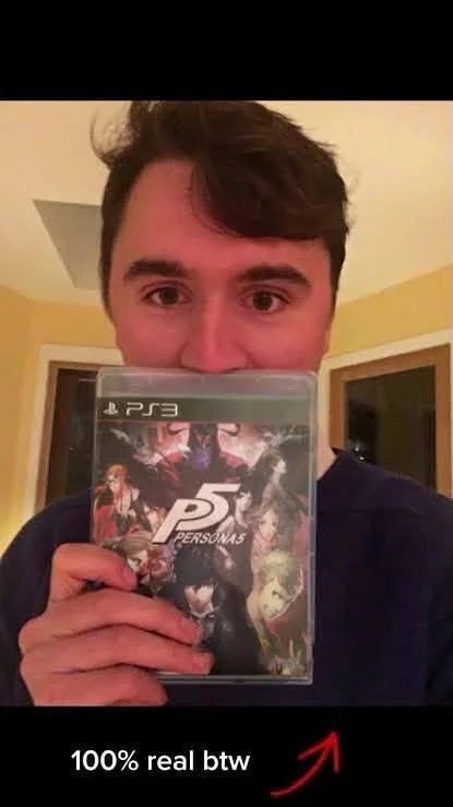 A man holding up a video game