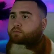 A man with a beard and a white shirt