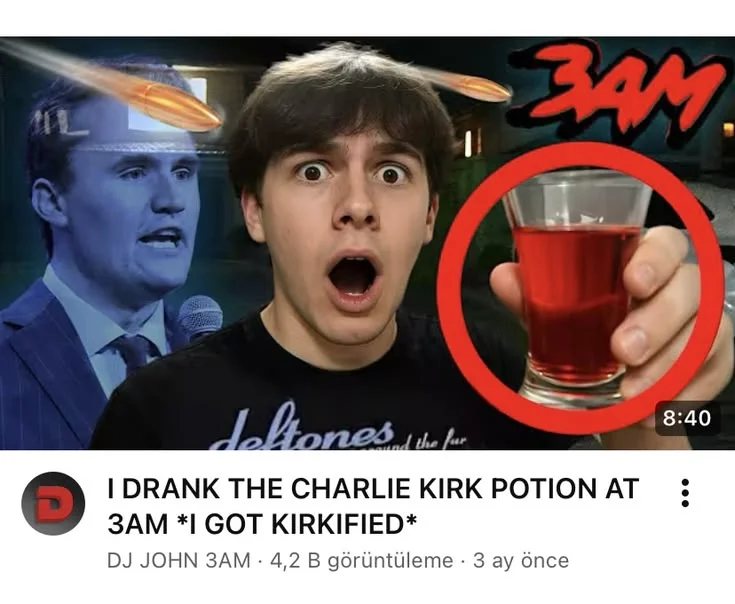 A man holding a glass of red liquid