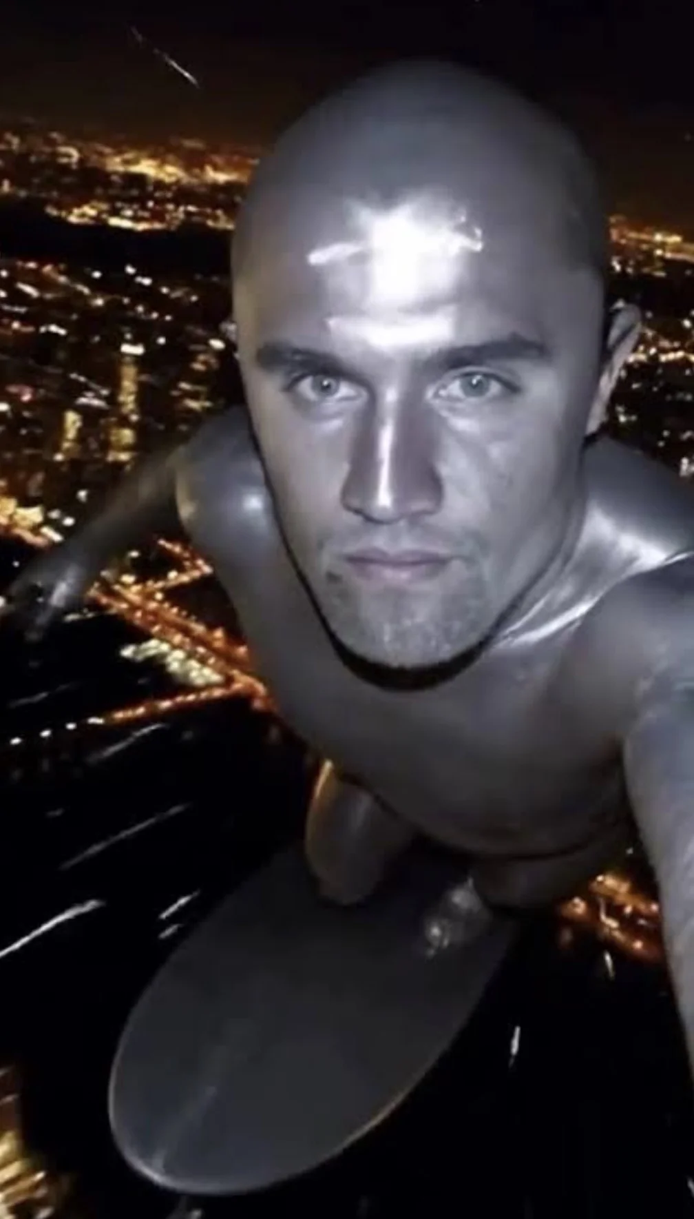 A man in a suit is suspended over the city
