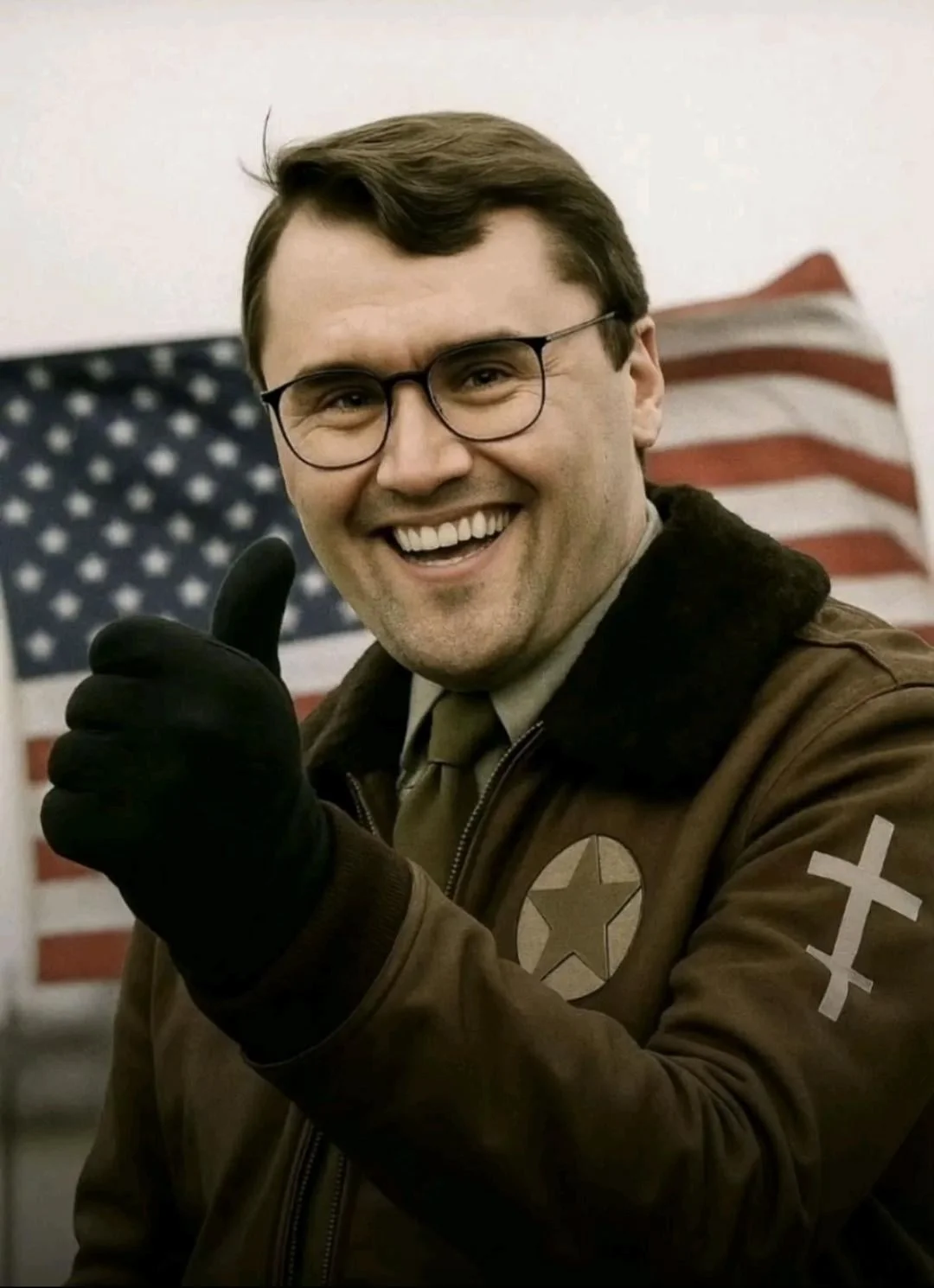 A man in a brown jacket and glasses is giving the thumbs