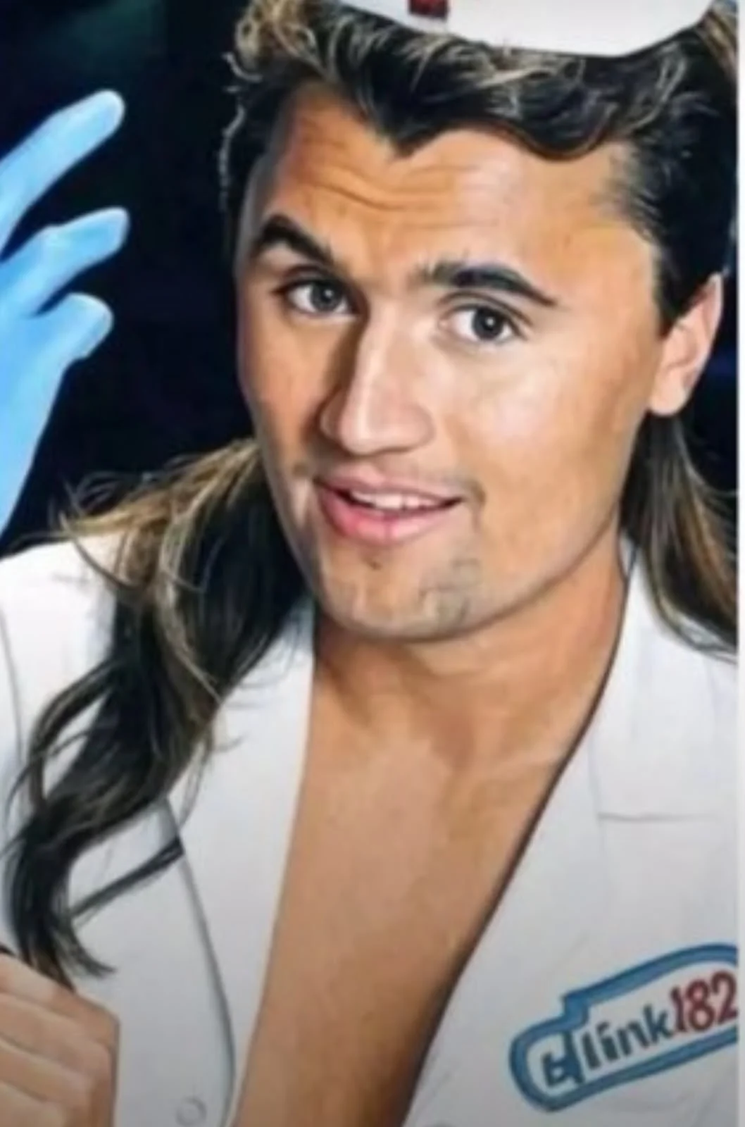 A man in a white suit and blue gloves