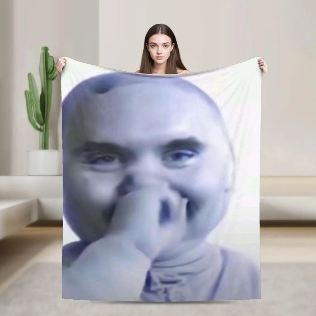 A woman holding a blanket with a photo of a man