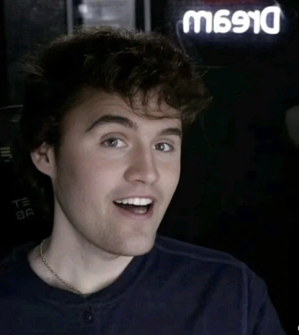 A man with a black shirt and a blue shirt