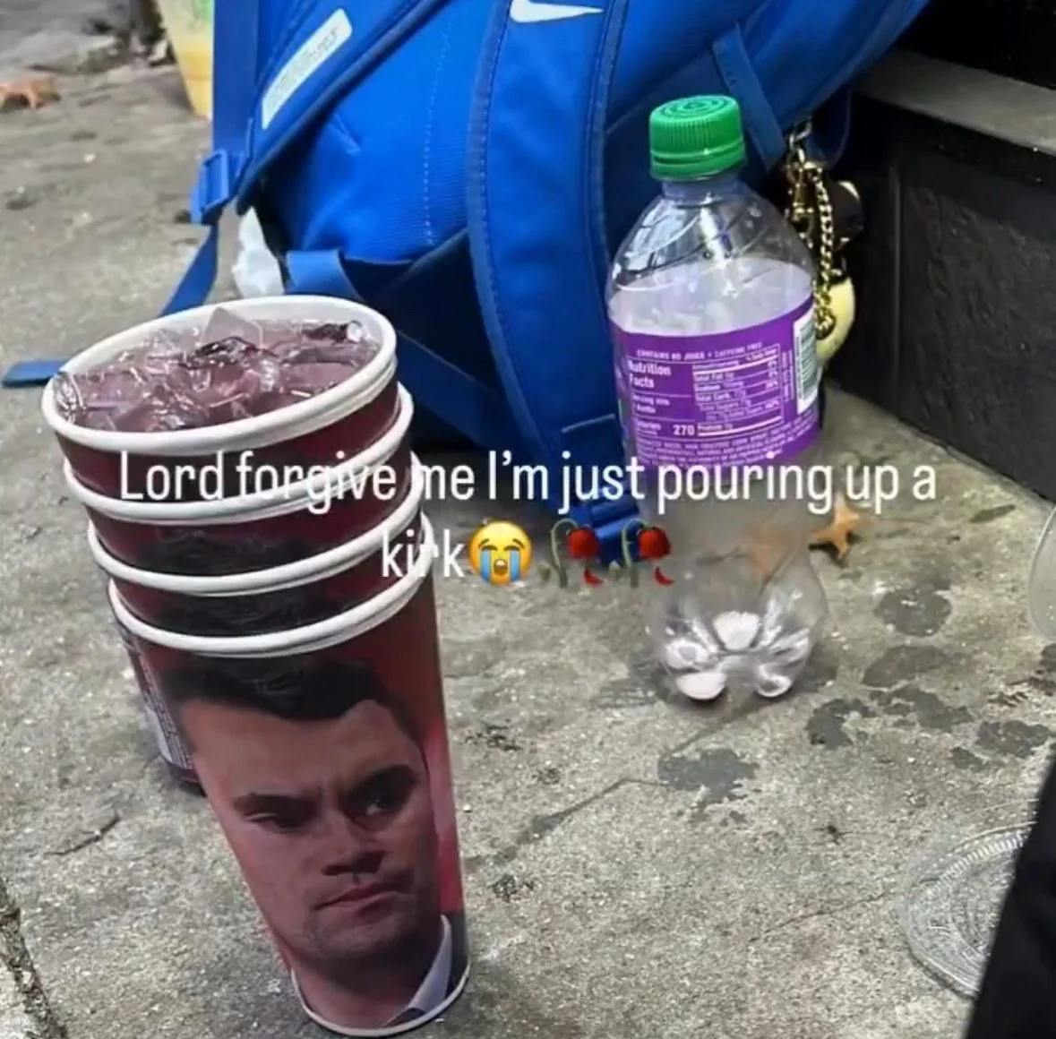A person is walking down the sidewalk with a cup