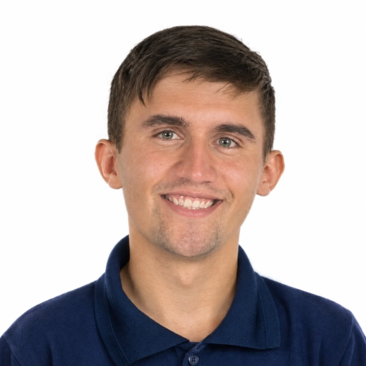 A man in a blue shirt smiles at the camera