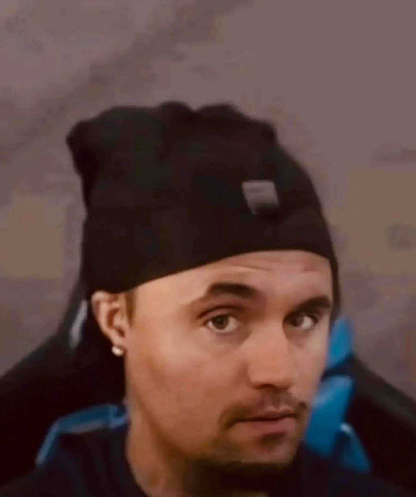 A man wearing a black hat