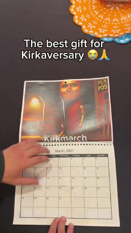 A person holding a calendar with a picture of a man